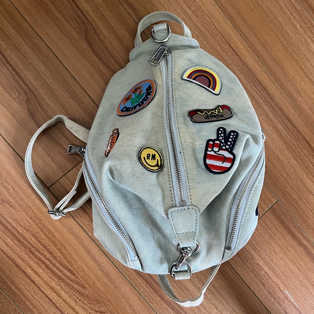 Rebecca Minkoff light gray backpack with colorful patch accents